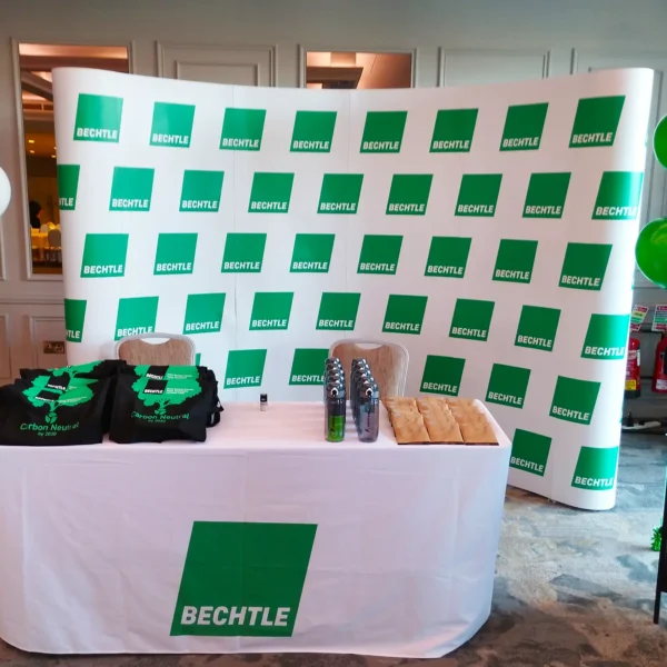 White and green Bechtle stand with balloons and branded merchandise