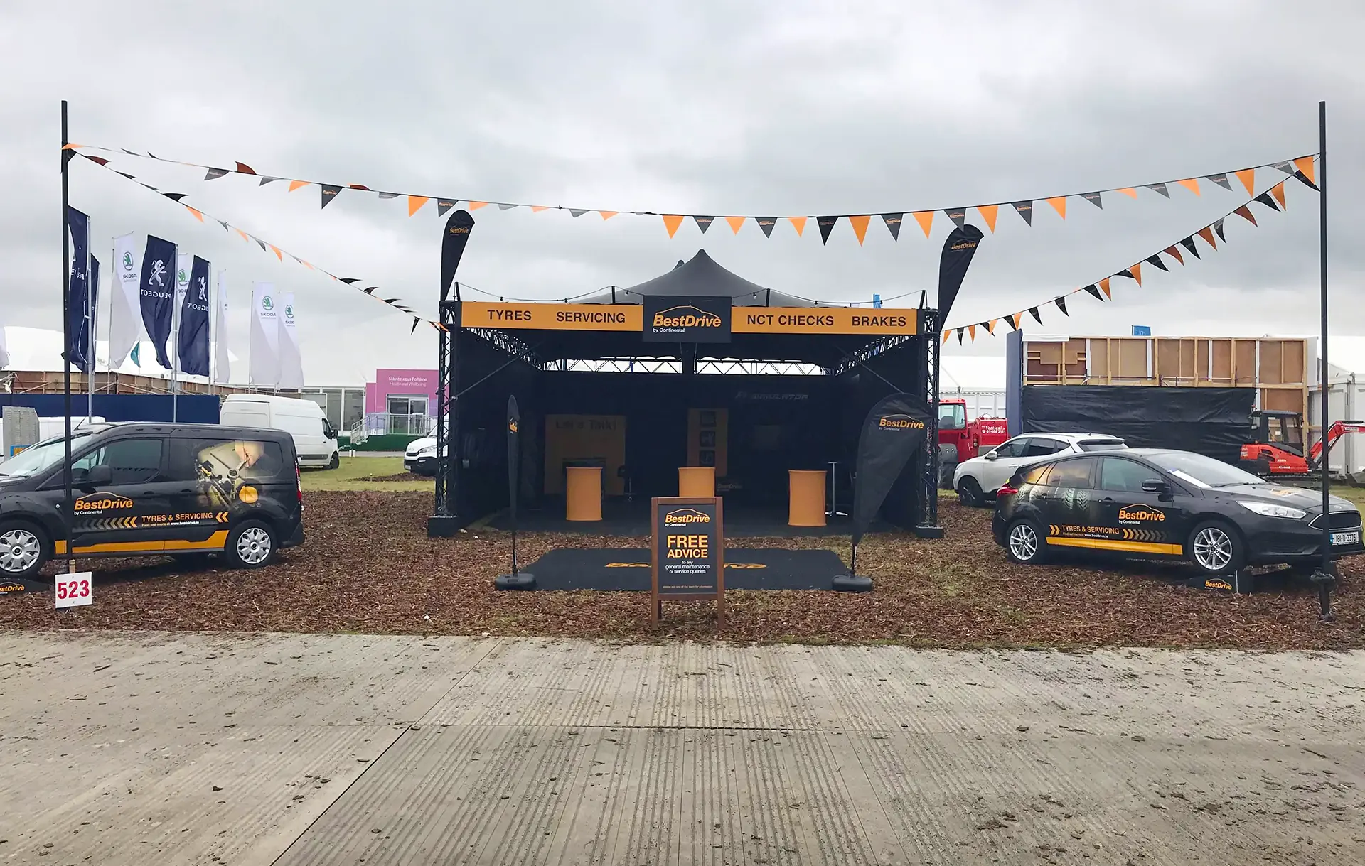 gazebo at trade fair for Best Drive. With Bunton's, car and van.