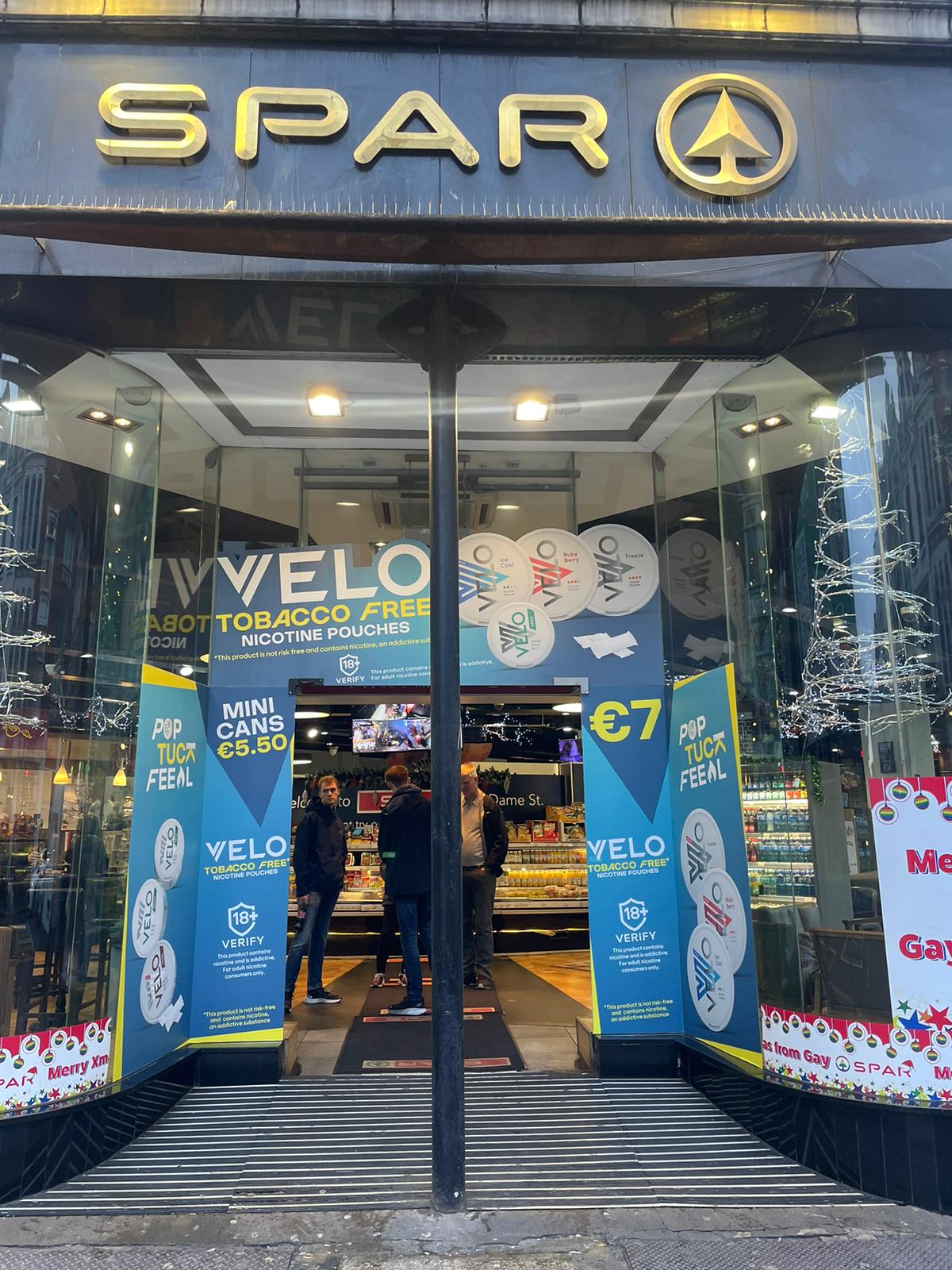 A shop front of a blue and yellow print signage wrap