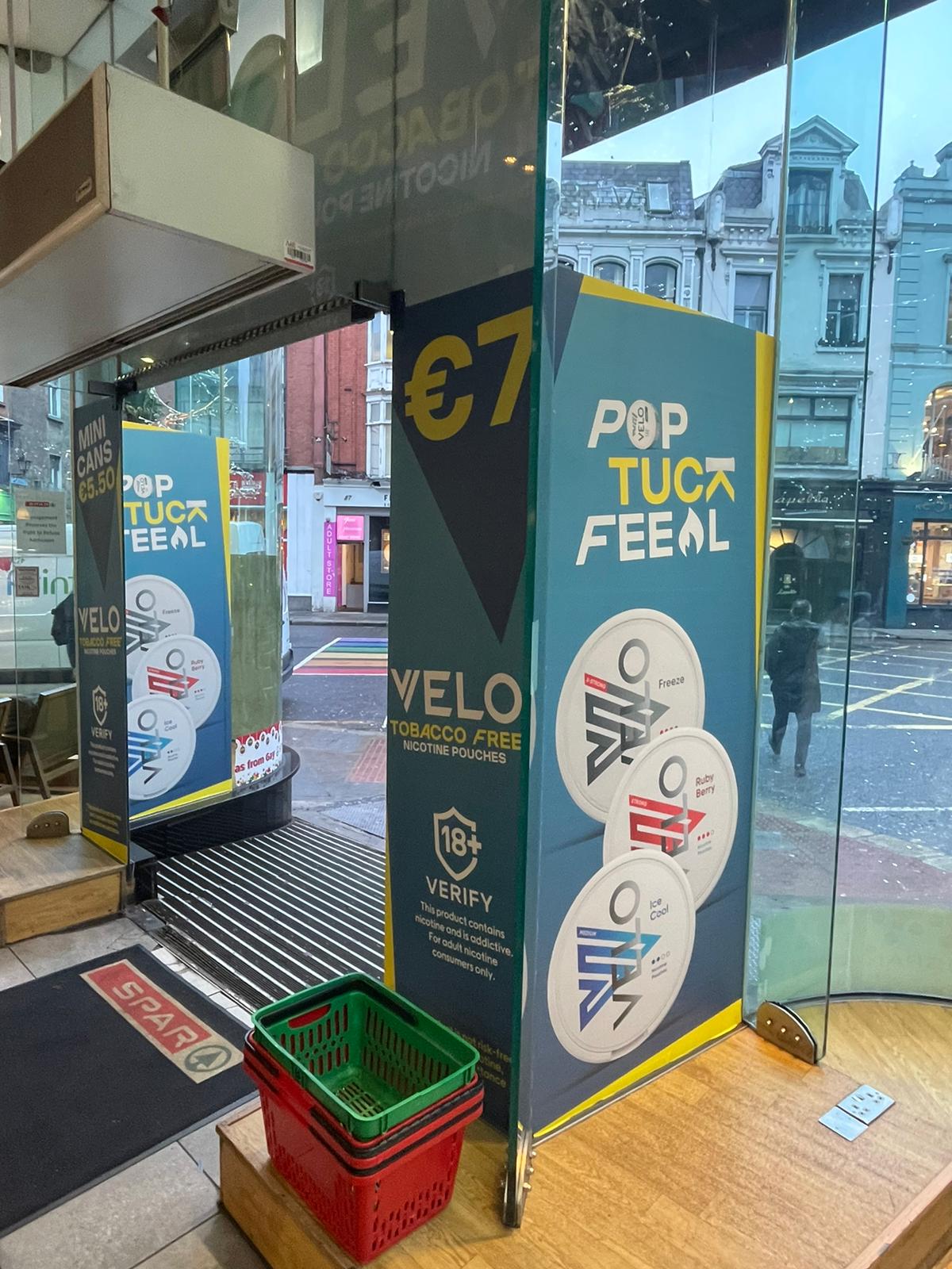 A shop front of a blue and yellow print signage wrap