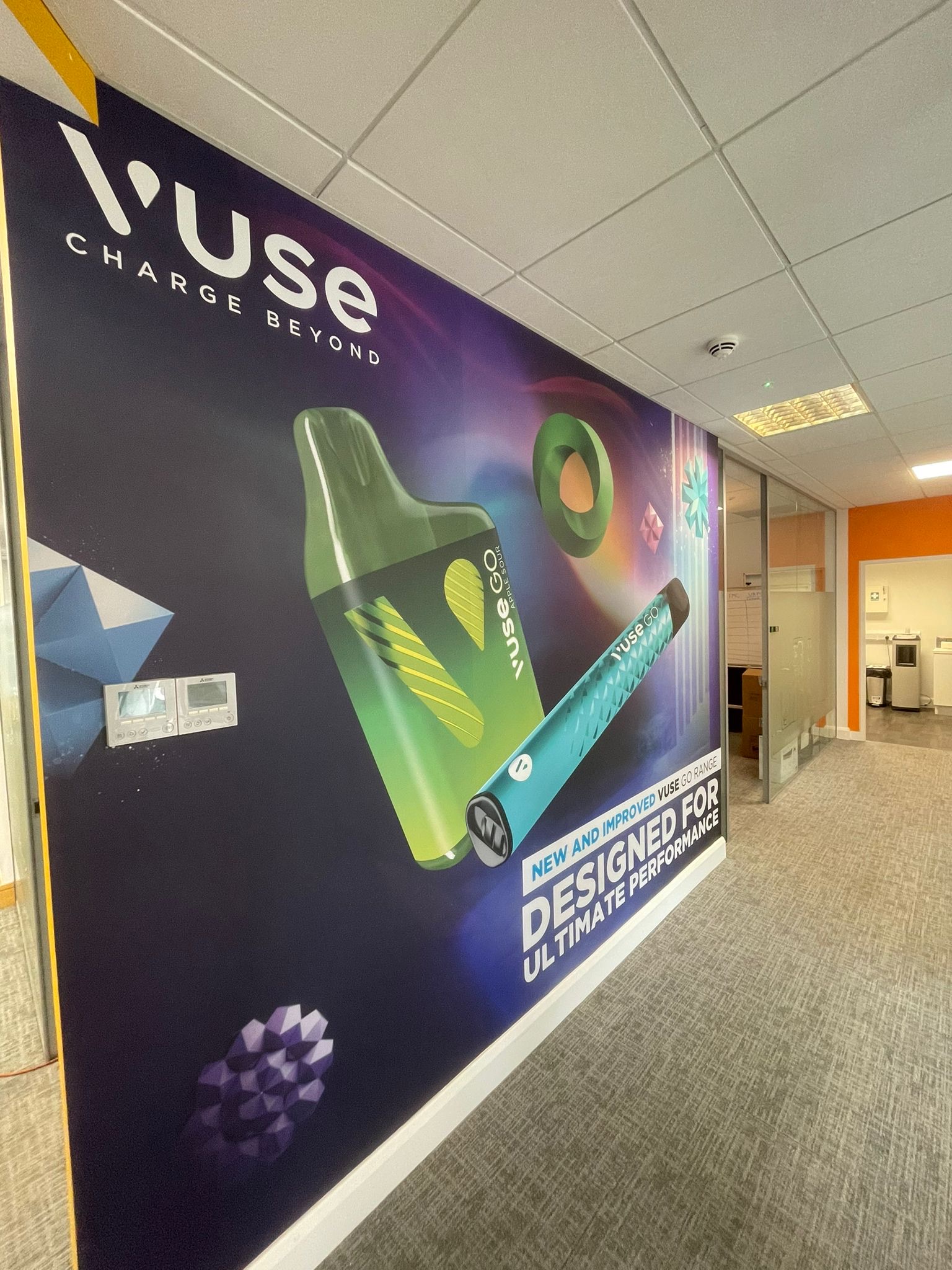 wall signage within a office building with colours green, blue, purple