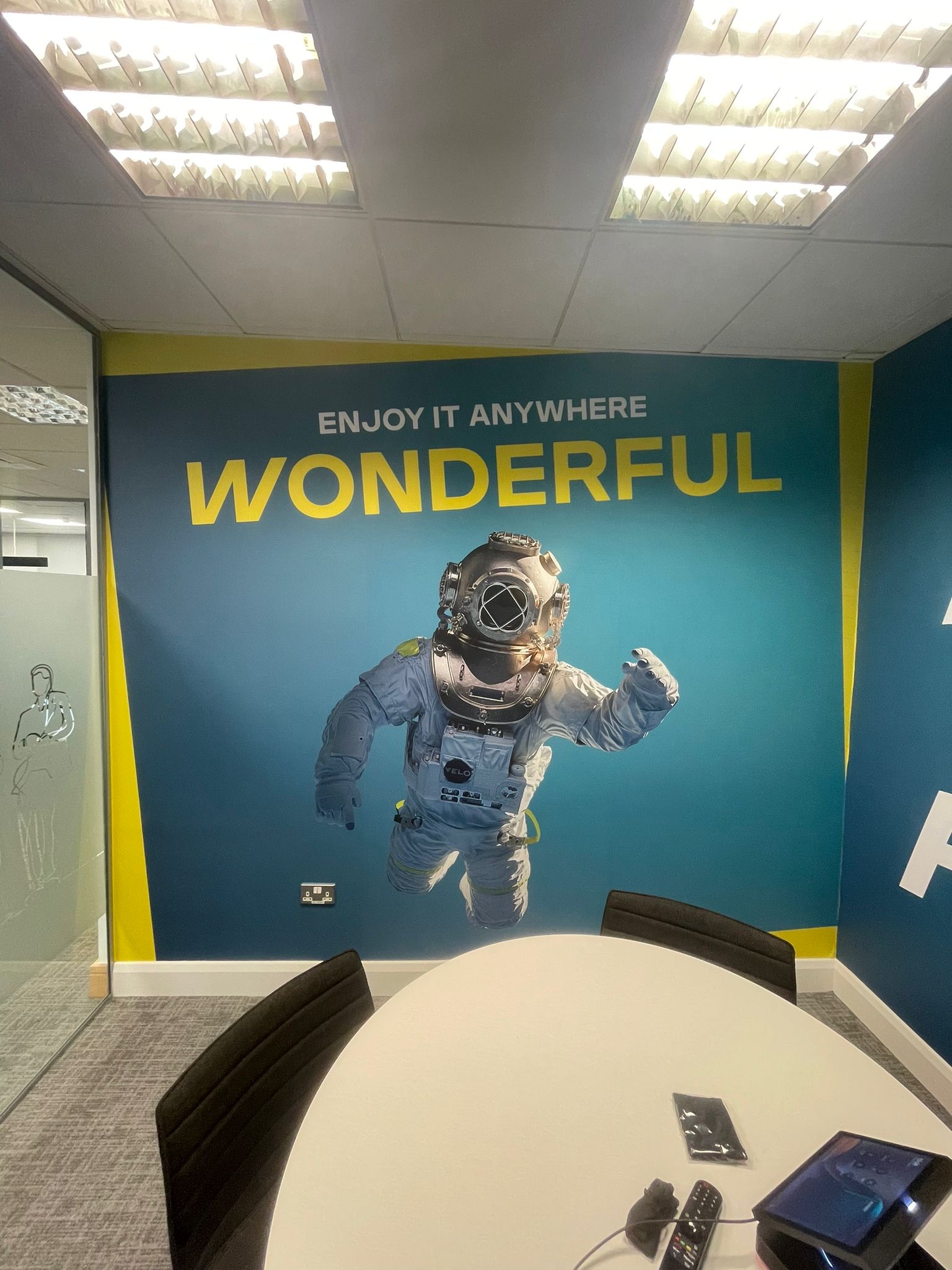 signage in an office building in Dublin that is blue and yellow with an astronaut on the front