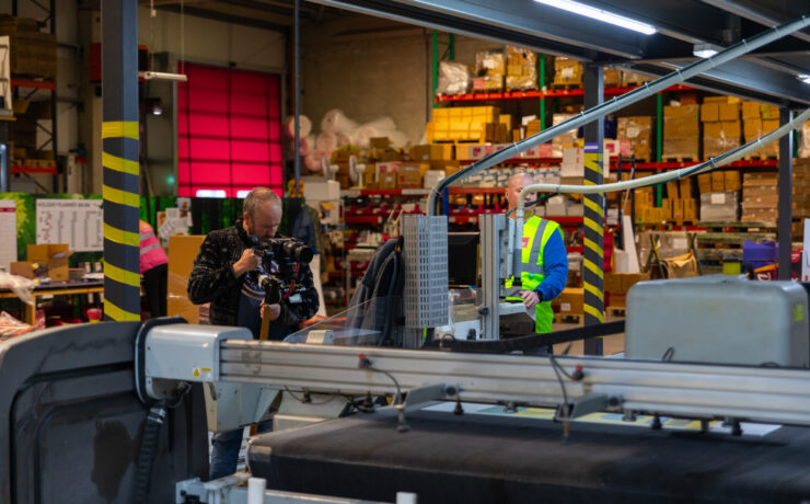 printing factory with a camera man recording the keyline machine